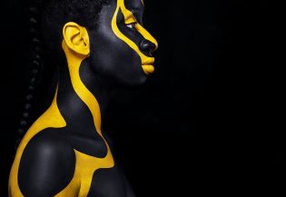 Art fashion makeup. An amazing woman with black makeup and leaking gold paint